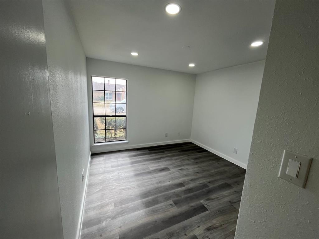 1105 Cherokee Trail Plano, TX 75023 - Photo 24 of 28 an empty room with wooden floor and windows