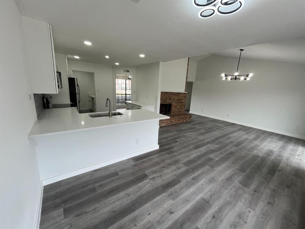 1105 Cherokee Trail Plano, TX 75023 - Photo 7 of 28 a view of a kitchen with a sink and a microwave
