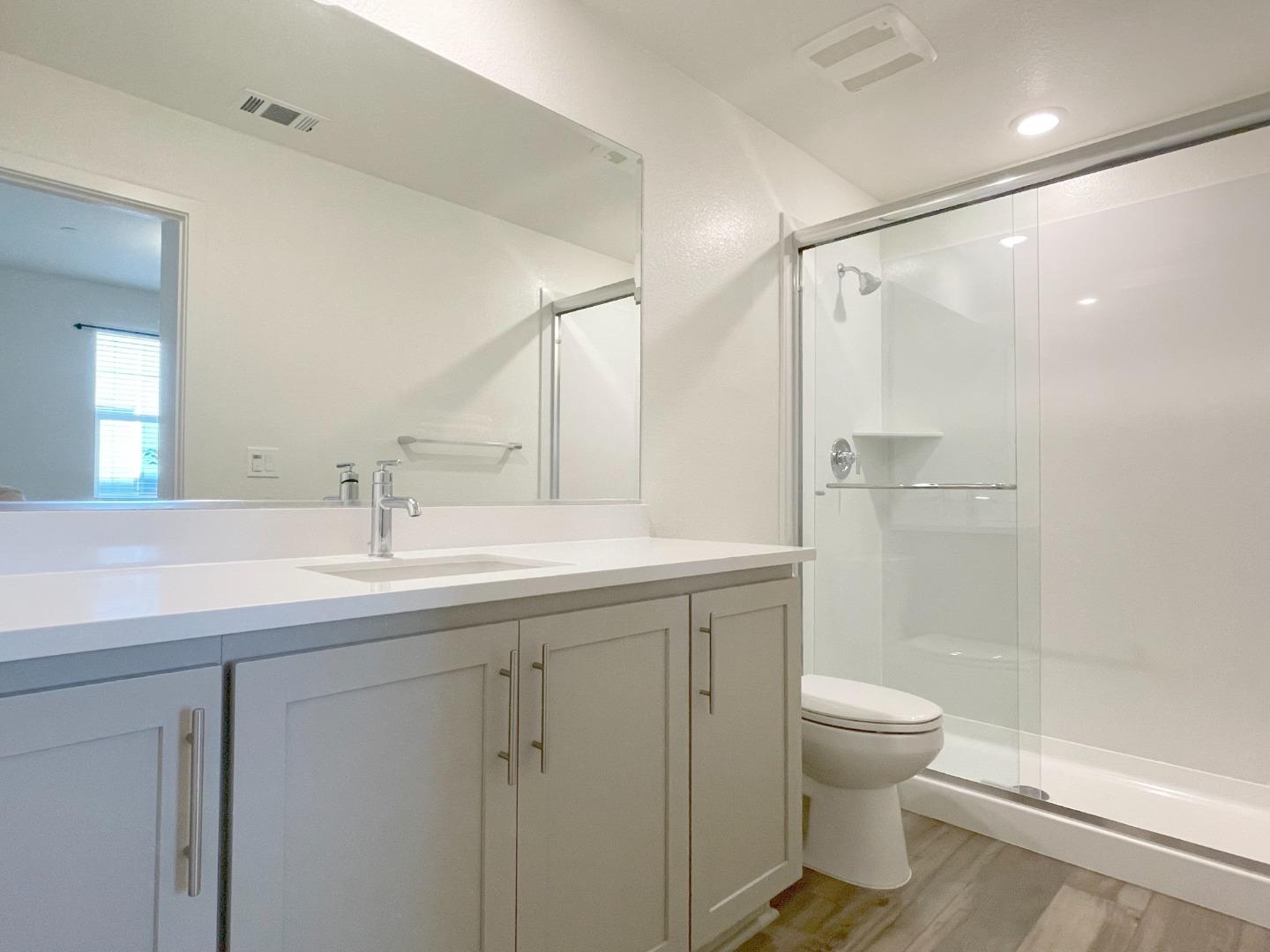 9600 Seawind Way Newark, CA 94560 - Photo 5 of 24 a bathroom with a shower sink vanity mirror and toilet