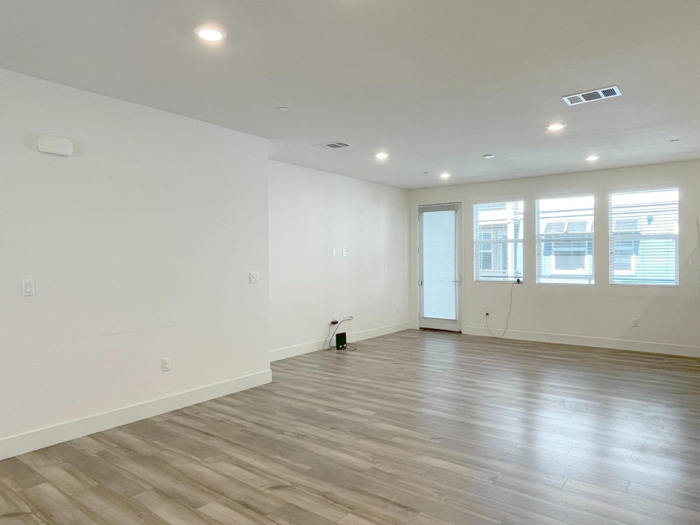 9600 Seawind Way Newark, CA 94560 - Photo 6 of 24 a view of an empty room with wooden floor and a window