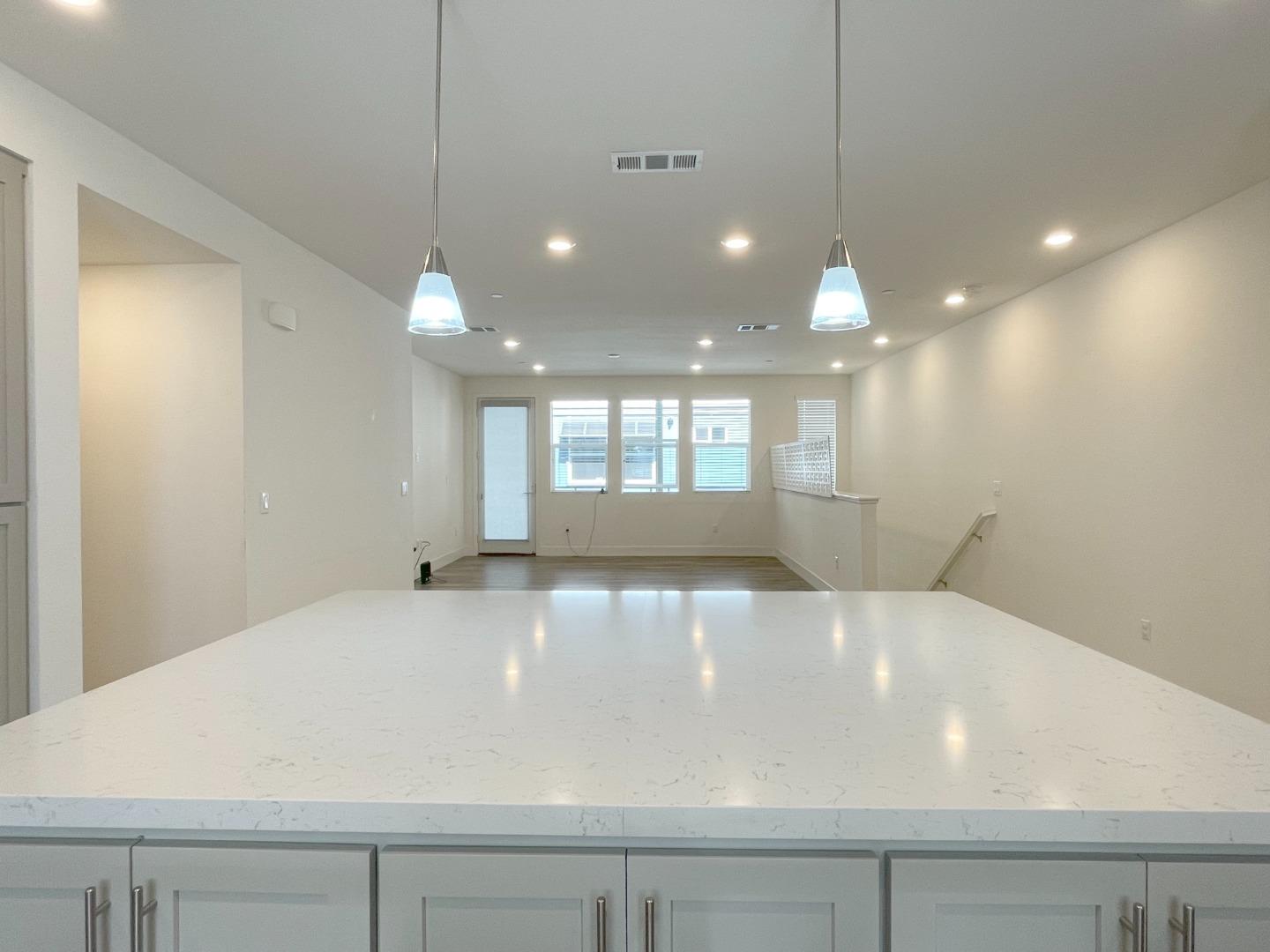 9600 Seawind Way Newark, CA 94560 - Photo 9 of 24 a large white kitchen with a large island oven a stove with kitchen island