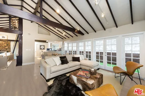 a living room with furniture and a floor to ceiling window