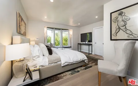 a bed room with a bed and a television