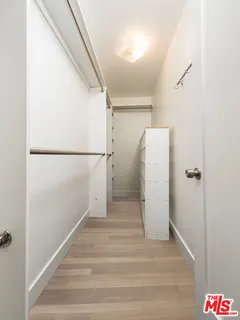 a view of a hallway with wooden floor and entryway