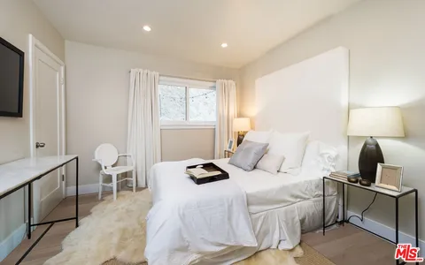 a bedroom with a bed and a lamp