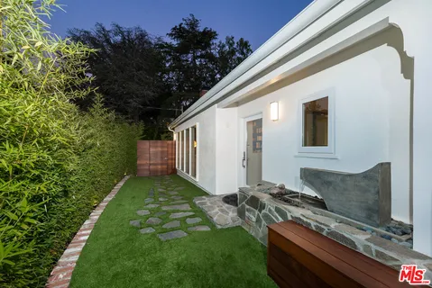 a backyard of a house with table and chairs