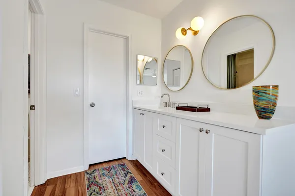 a white toilet sitting next to a bath tub