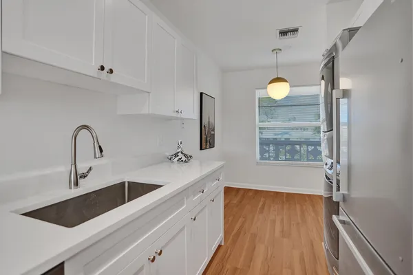 a view of cabinets and wooden floor