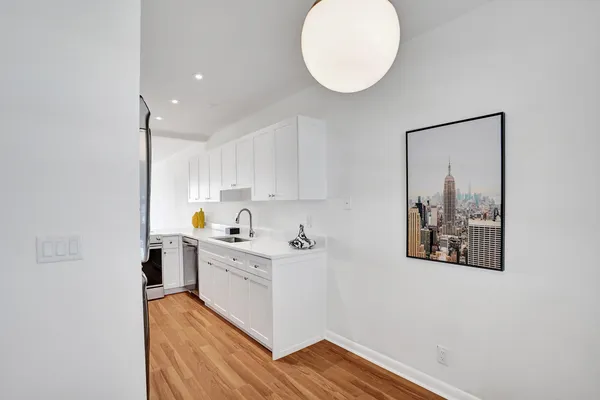 a kitchen with a cabinets and wooden floor
