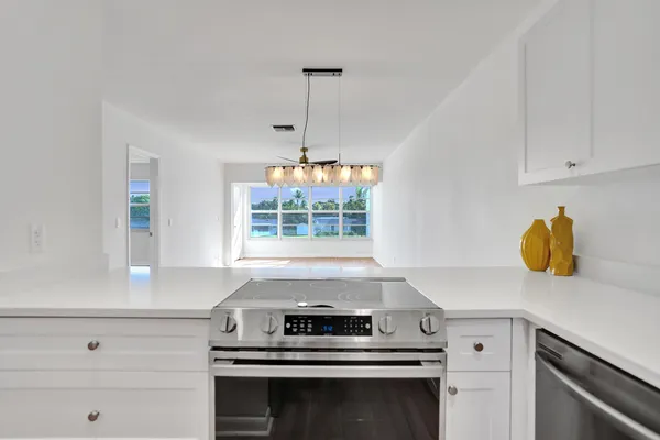 a kitchen with a stove and a white cabinets