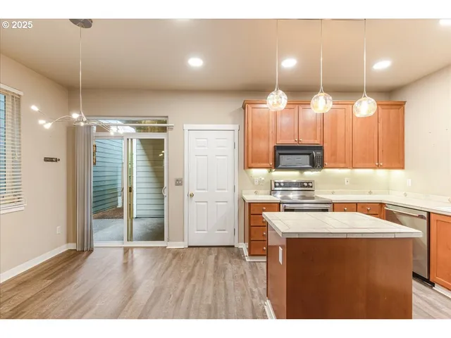 a kitchen with a refrigerator a sink and a microwave