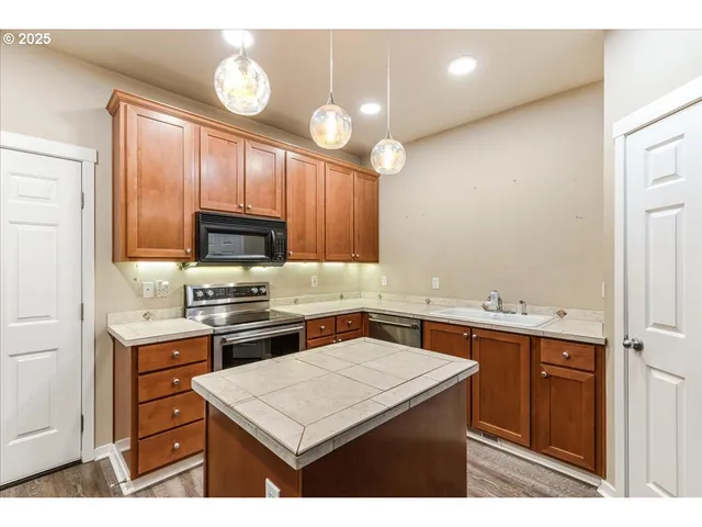 a bathroom with a sink a large mirror and a shower