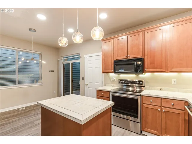 a kitchen with cabinets and a refrigerator