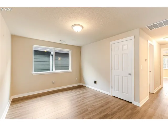 a view of an empty room and wooden floor