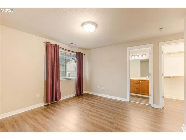a view of an empty room and wooden floor