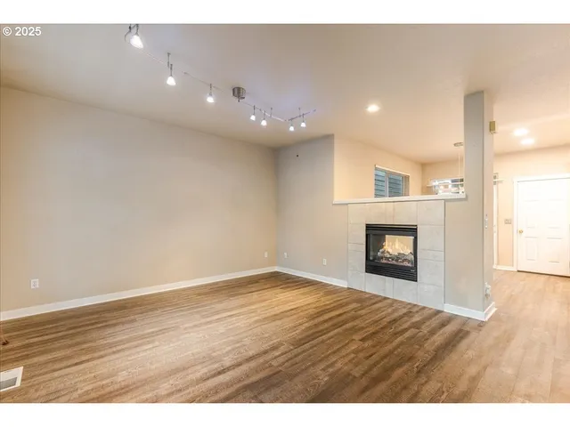 a kitchen with stainless steel appliances a sink a stove a refrigerator and cabinets