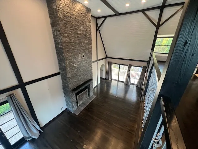 a living room with wooden floor and a fireplace