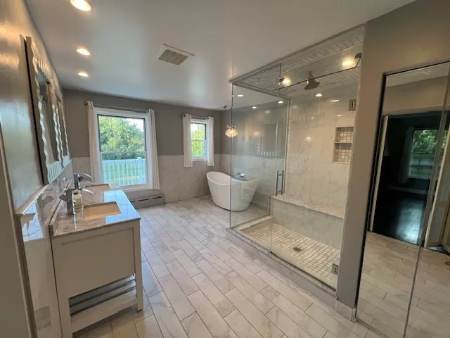 an empty room with a windows and chandelier fan