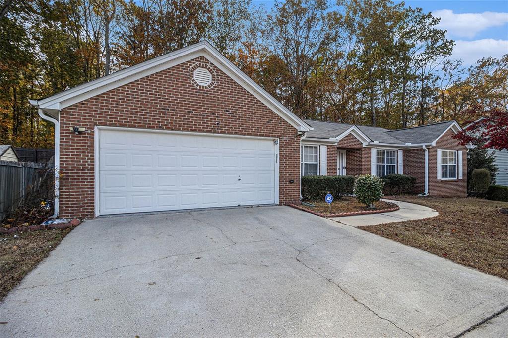 5937 Valley Green Road Lithonia, GA 30058 - Photo 1 of 1 a front view of a house with a yard and garage
