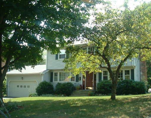 front view of a house with a tree
