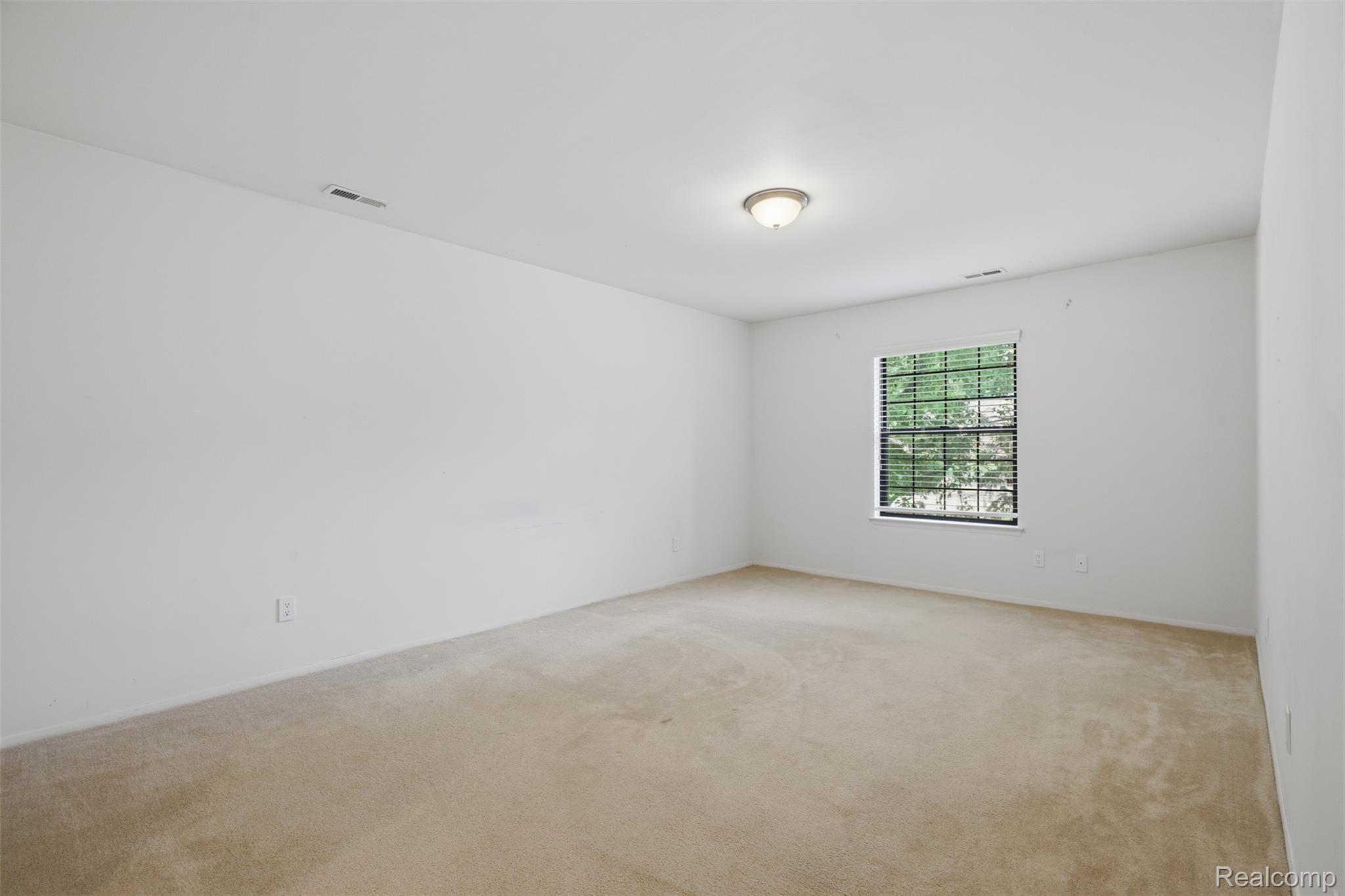 29726 Pine Ridge Circle Farmington, MI 48331 - Photo 12 of 40 Light-filled room featuring carpet flooring, crisp white walls