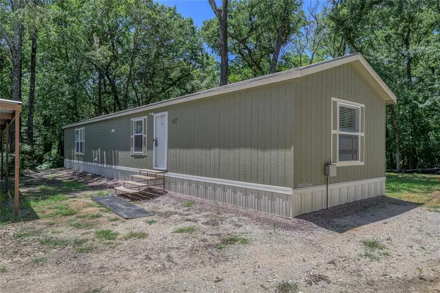 a backyard of a house with plants and outdoor space