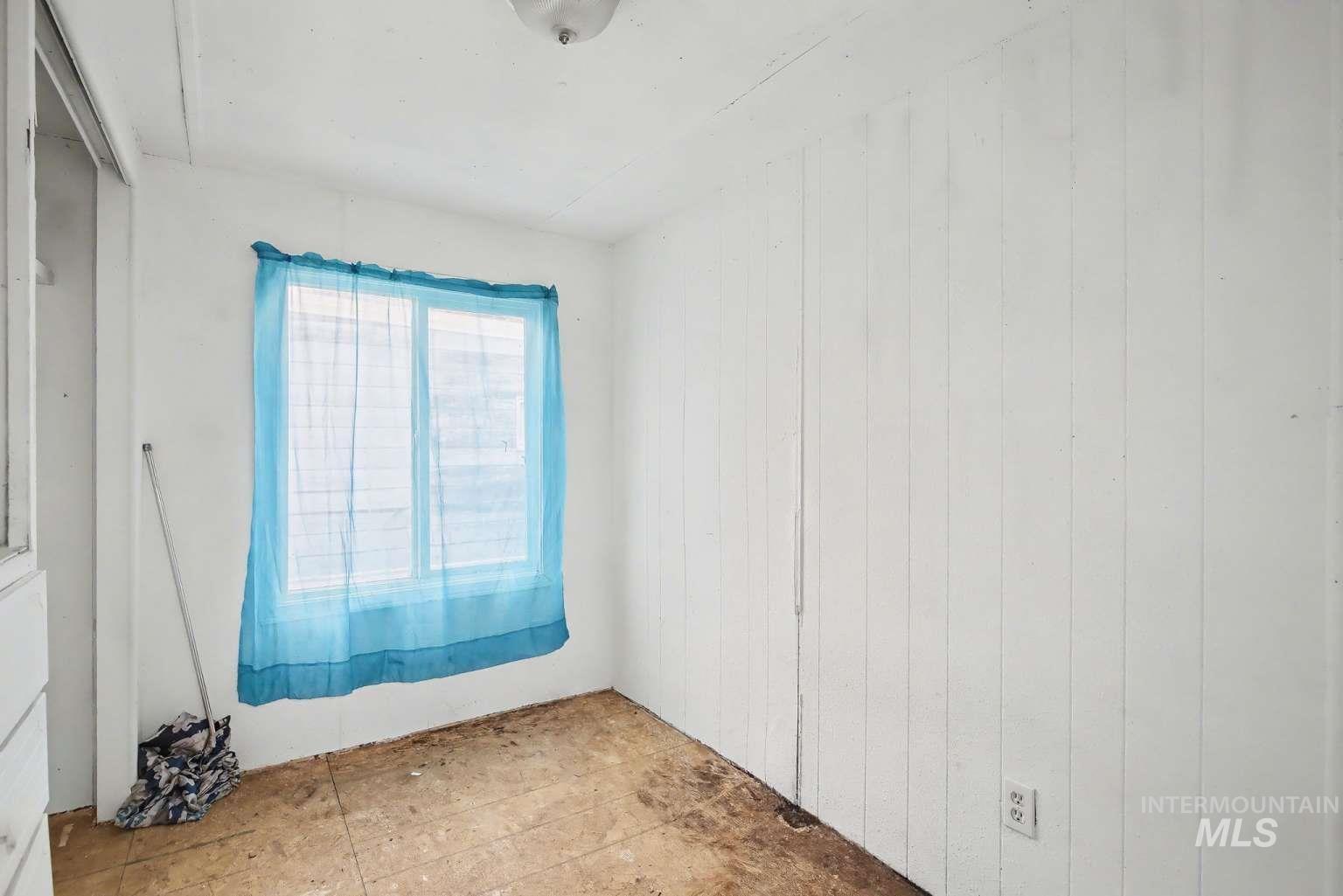 628 Burrell Avenue, Unit 5 Lewiston, ID 83501 - Photo 12 of 15 Spare room with wooden walls