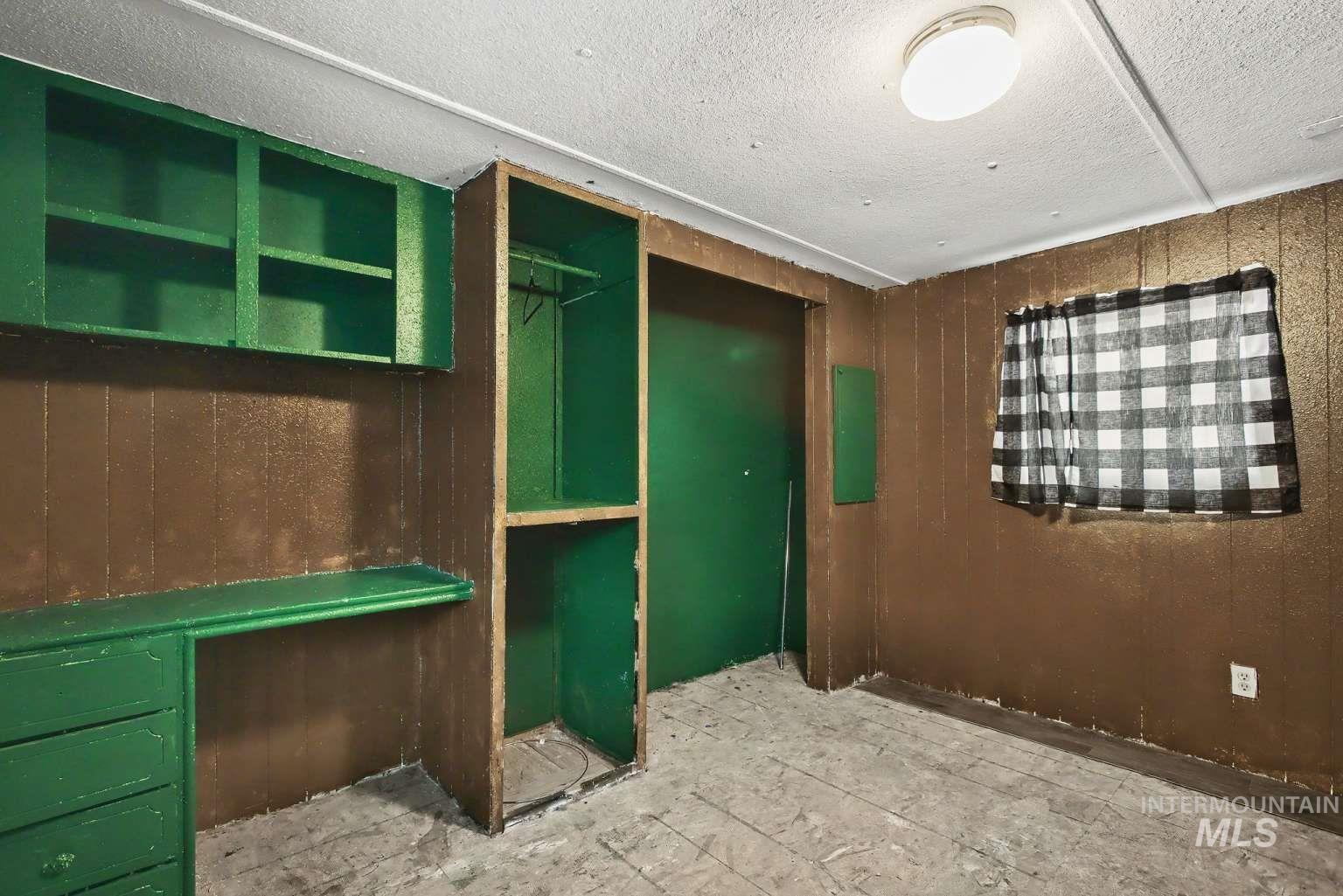 628 Burrell Avenue, Unit 5 Lewiston, ID 83501 - Photo 7 of 15 Unfurnished office featuring wooden walls and a textured ceiling
