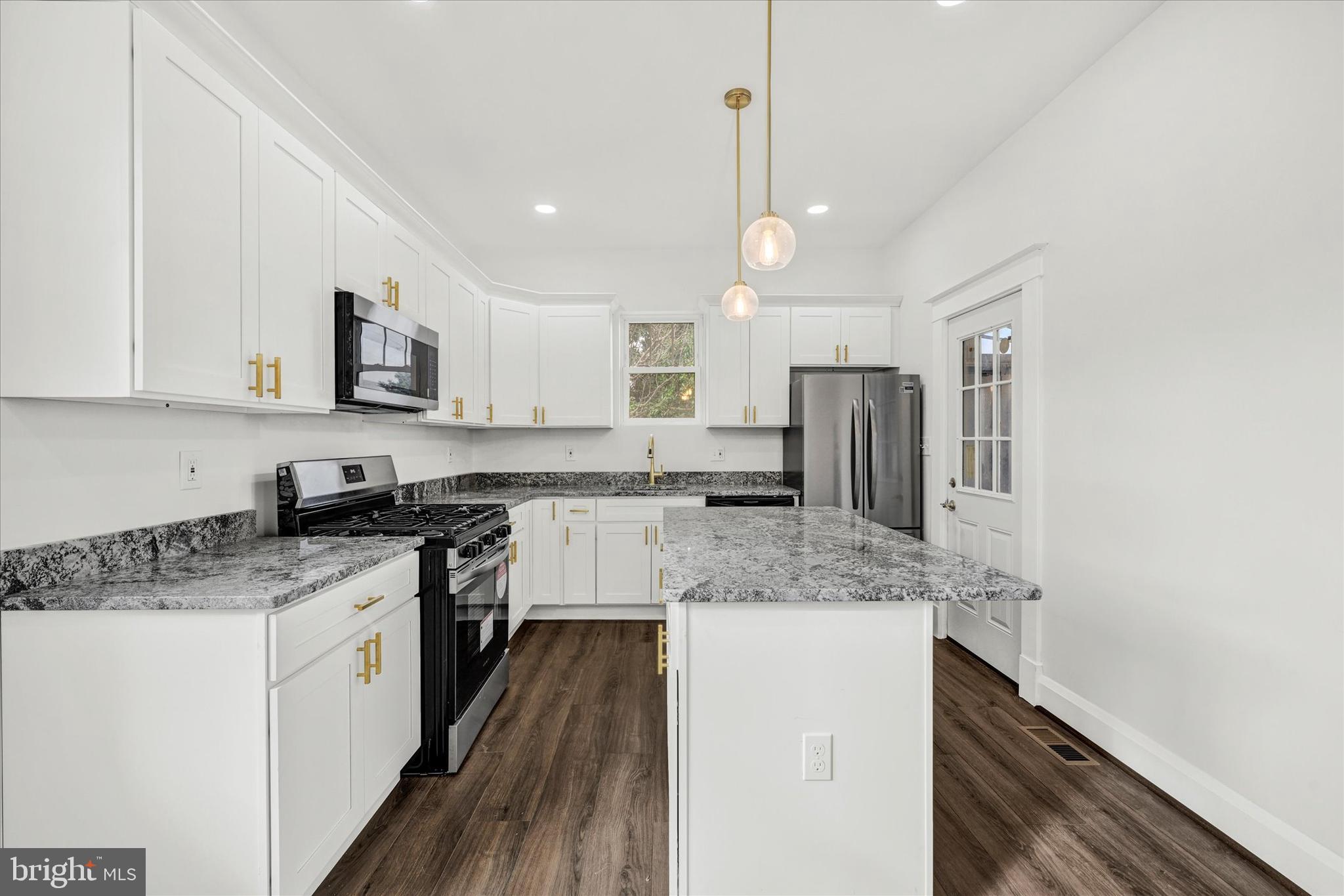 1127 Chesaco Avenue Rosedale, MD 21237 - Photo 11 of 38 a kitchen with stainless steel appliances granite countertop a sink stove and refrigerator