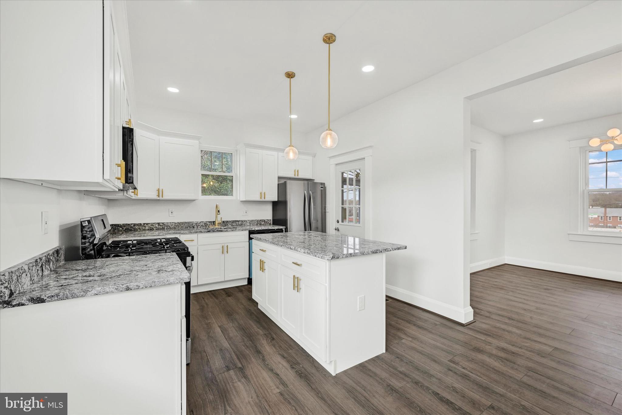 1127 Chesaco Avenue Rosedale, MD 21237 - Photo 13 of 38 a kitchen with granite countertop a sink cabinets and wooden floor