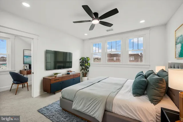 a bedroom with a bed furniture and a flat screen tv
