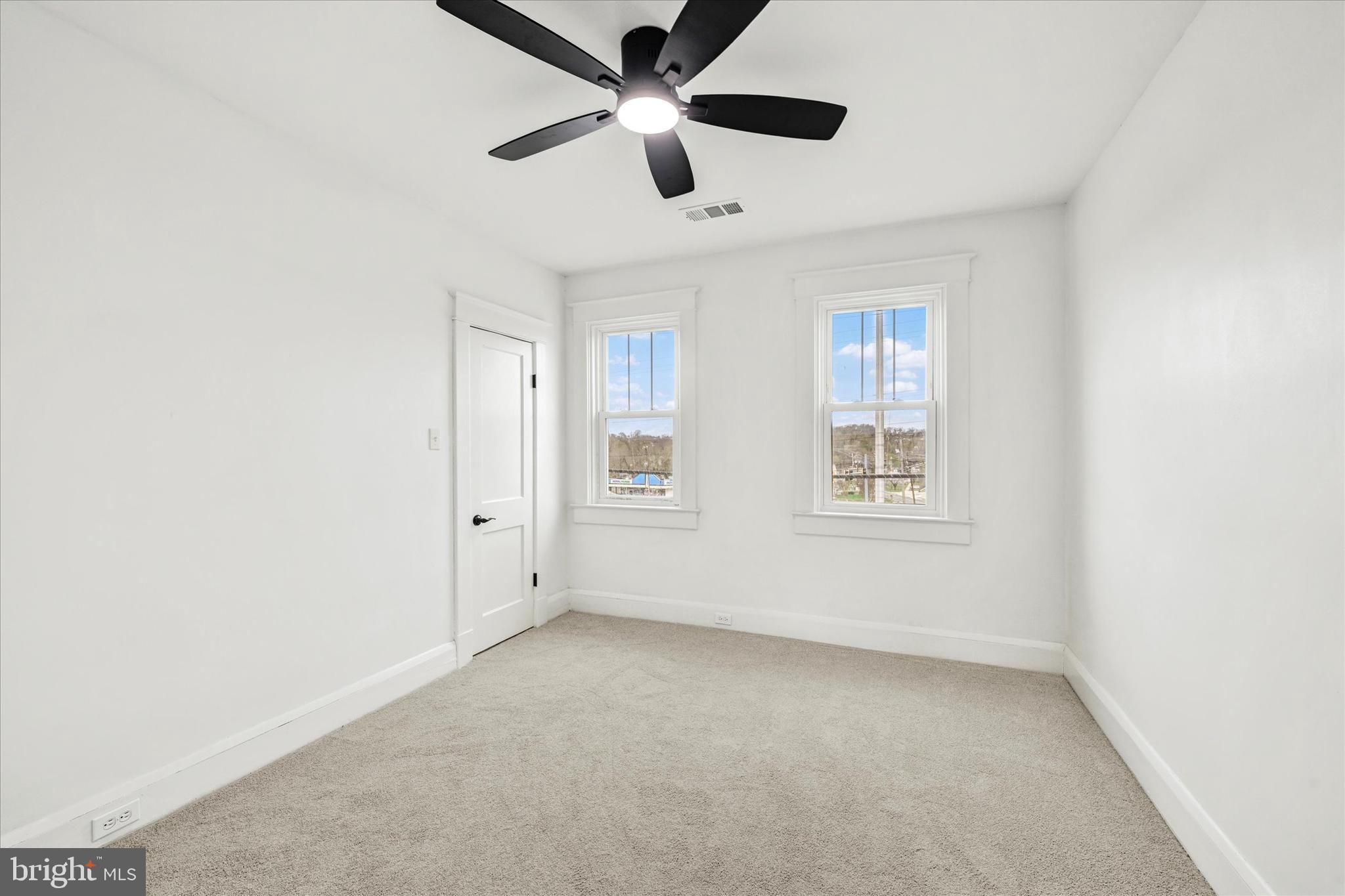 1127 Chesaco Avenue Rosedale, MD 21237 - Photo 22 of 38 an empty room with ceiling fan and windows