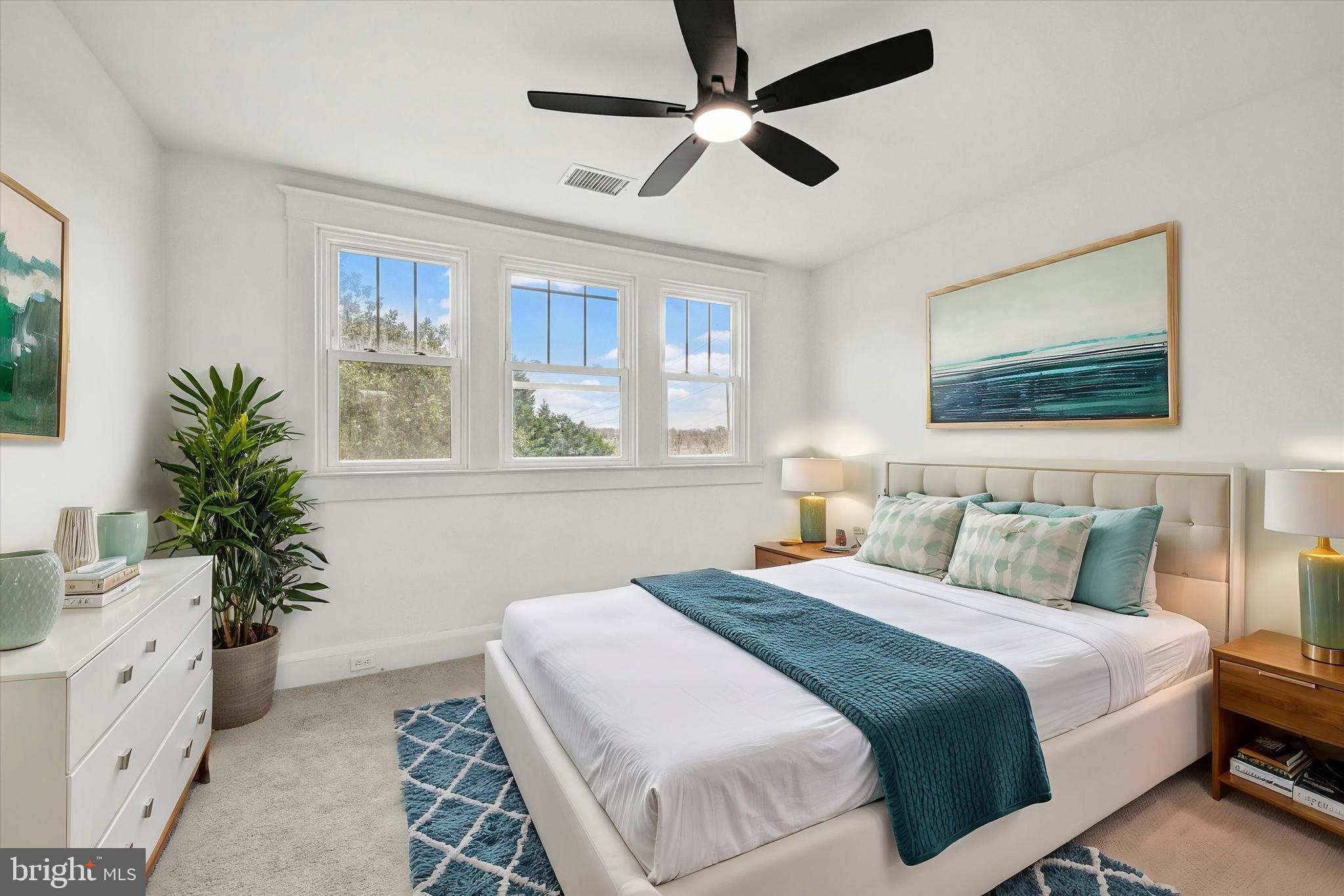 1127 Chesaco Avenue Rosedale, MD 21237 - Photo 23 of 38 a bedroom with a large bed and a chandelier