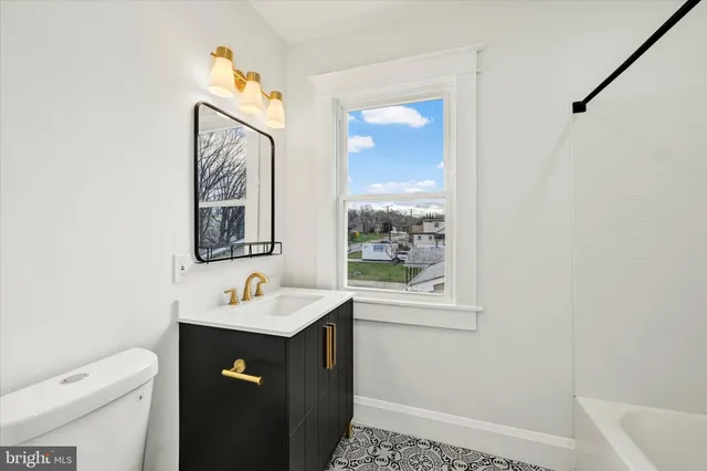 a bathroom with a sink vanity and a mirror