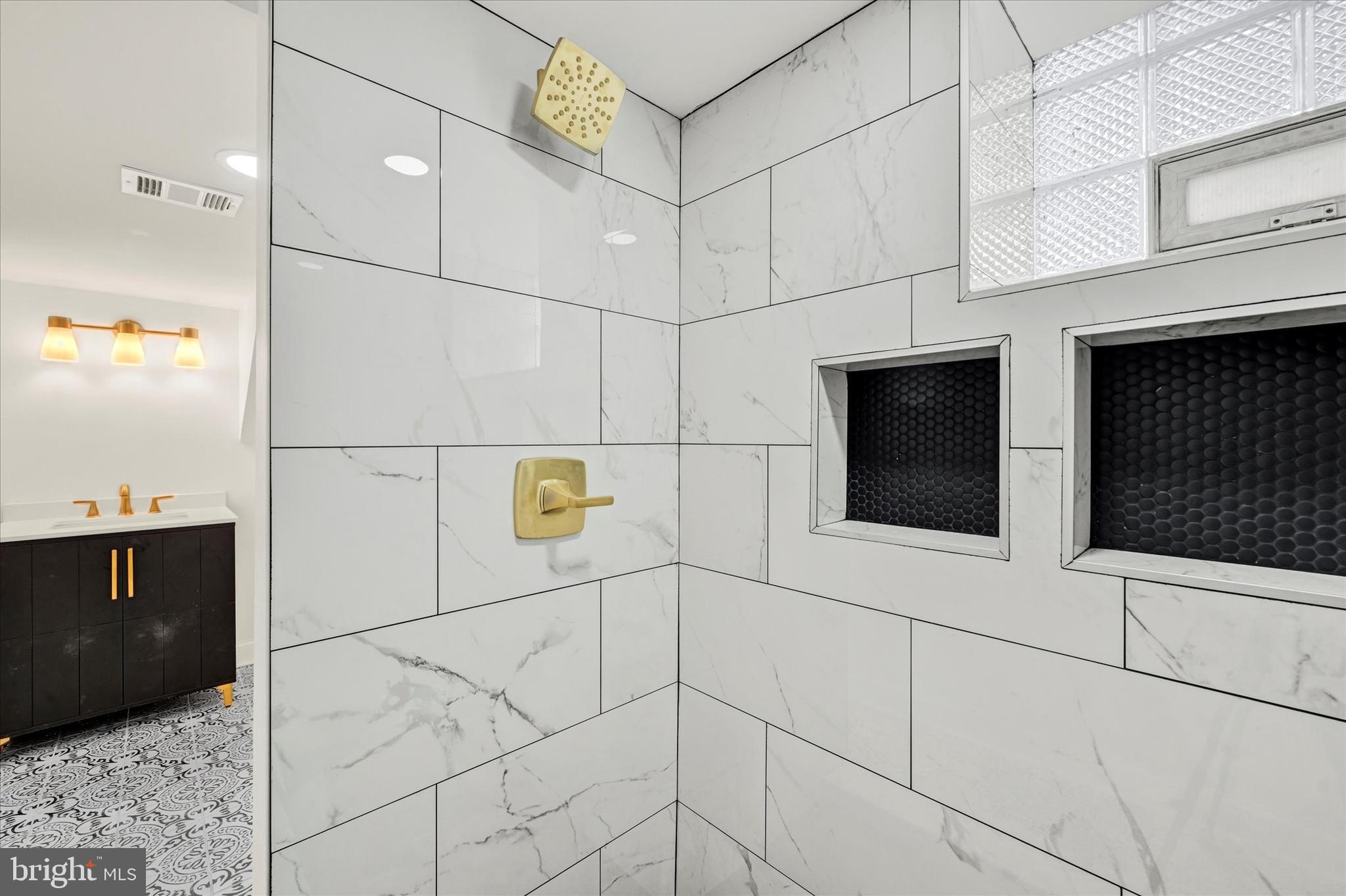 1127 Chesaco Avenue Rosedale, MD 21237 - Photo 32 of 38 a bathroom with a shower and a mirror