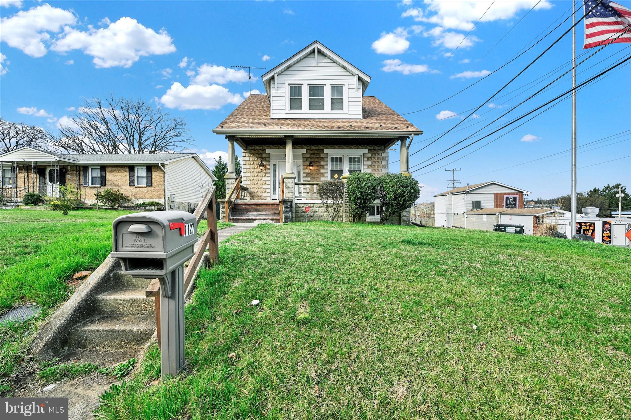 1127 Chesaco Avenue Rosedale, MD 21237 - Photo 37 of 38 a front view of a house with a yard table and chairs