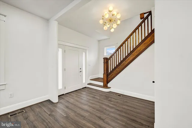 a view of an entryway with wooden floor