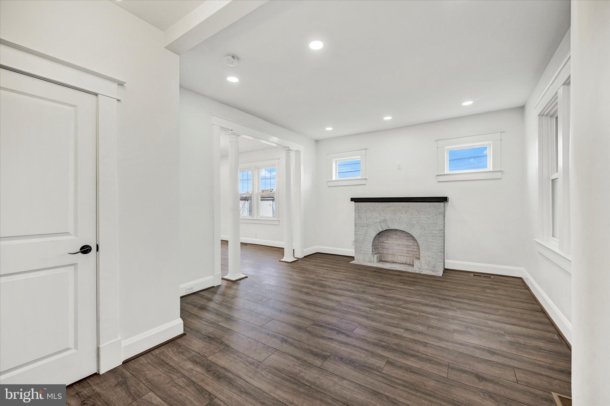 1127 Chesaco Avenue Rosedale, MD 21237 - Photo 6 of 38 a view of an empty room with wooden floor and a window