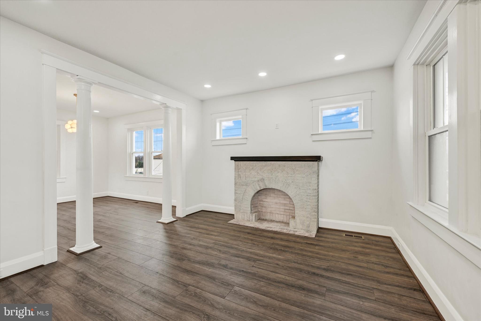 1127 Chesaco Avenue Rosedale, MD 21237 - Photo 7 of 38 a view of empty room with wooden floor and fireplace