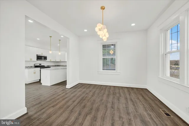 a view of a kitchen with a sink wooden floor and a window