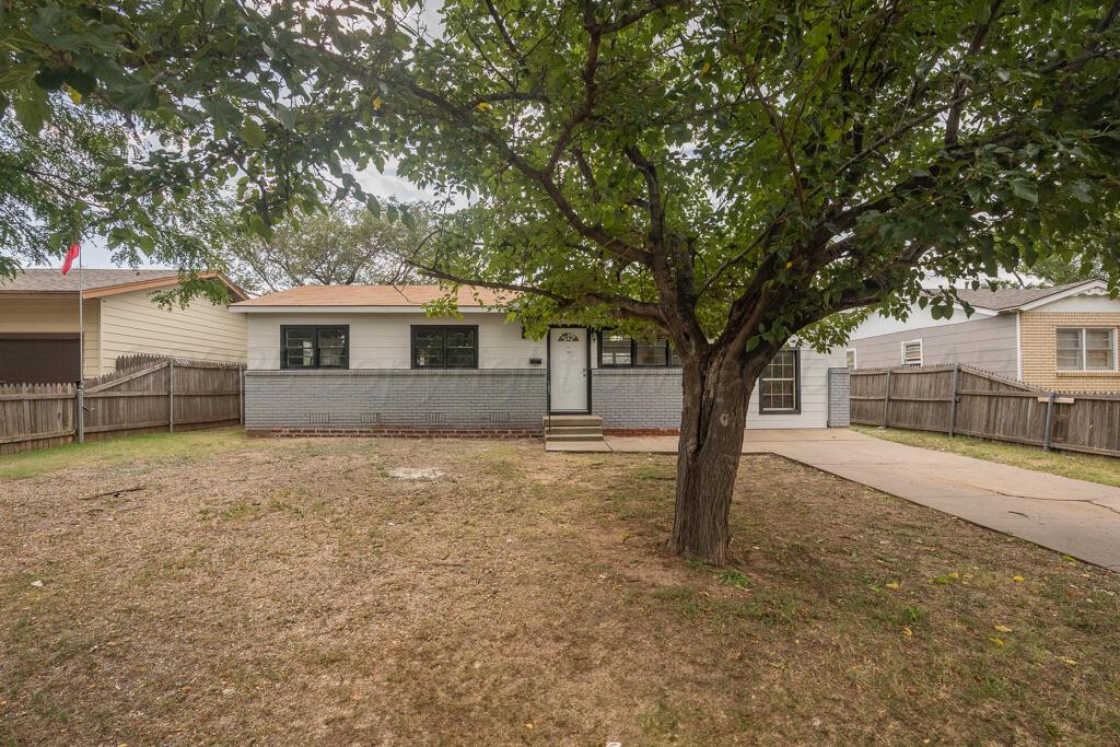 5122 Crockett Street Amarillo, TX 79110 - Photo 1 of 17 a front view of a house with a tree