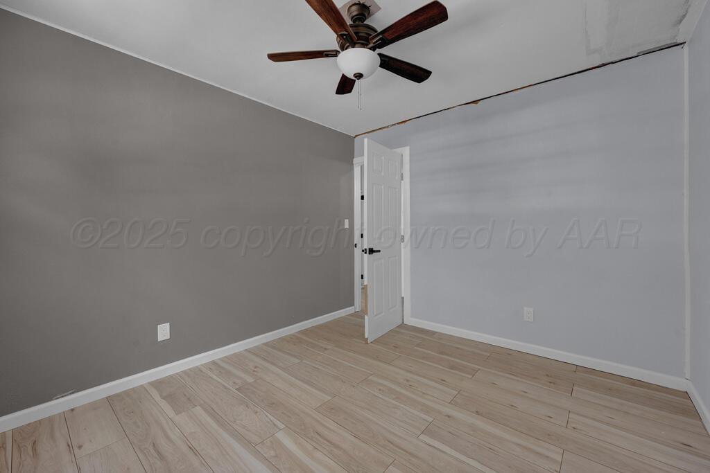 5122 Crockett Street Amarillo, TX 79110 - Photo 12 of 17 wooden floor in an empty room