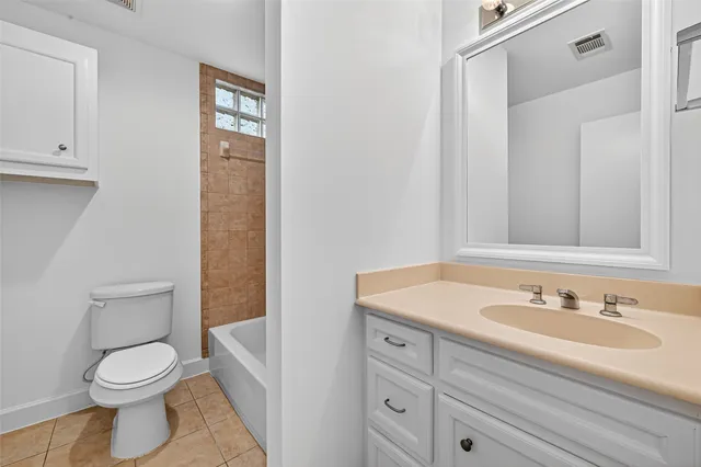 a kitchen with granite countertop white cabinets and stainless steel appliances