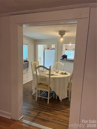 a dining room with furniture and wooden floor