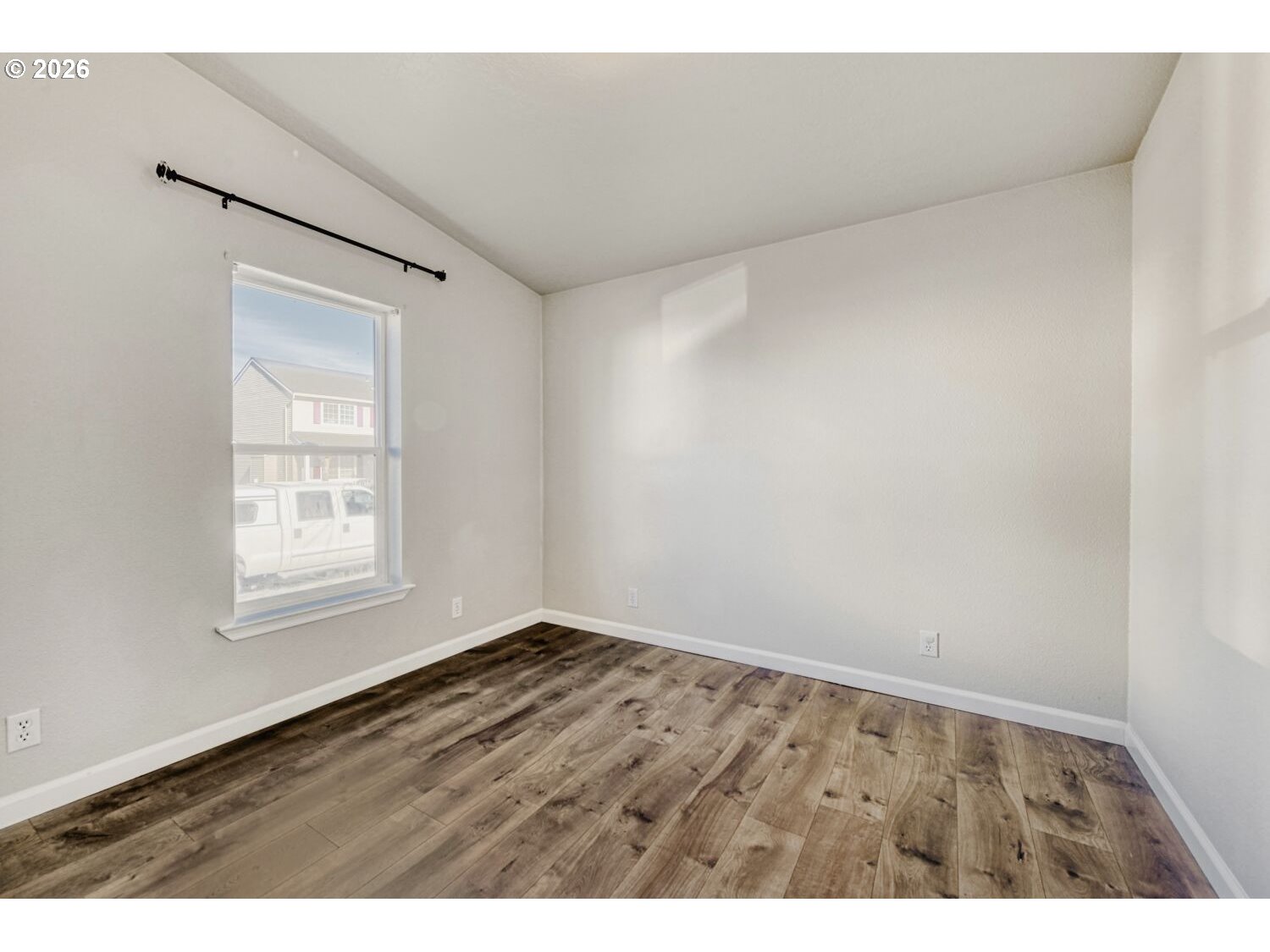 2431 North Fremont Street Cornelius, OR 97113 - Photo 13 of 29 a view of an empty room with wooden floor and a window