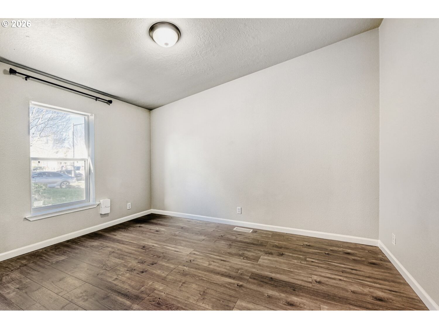 2431 North Fremont Street Cornelius, OR 97113 - Photo 14 of 29 a view of an empty room with wooden floor and a window