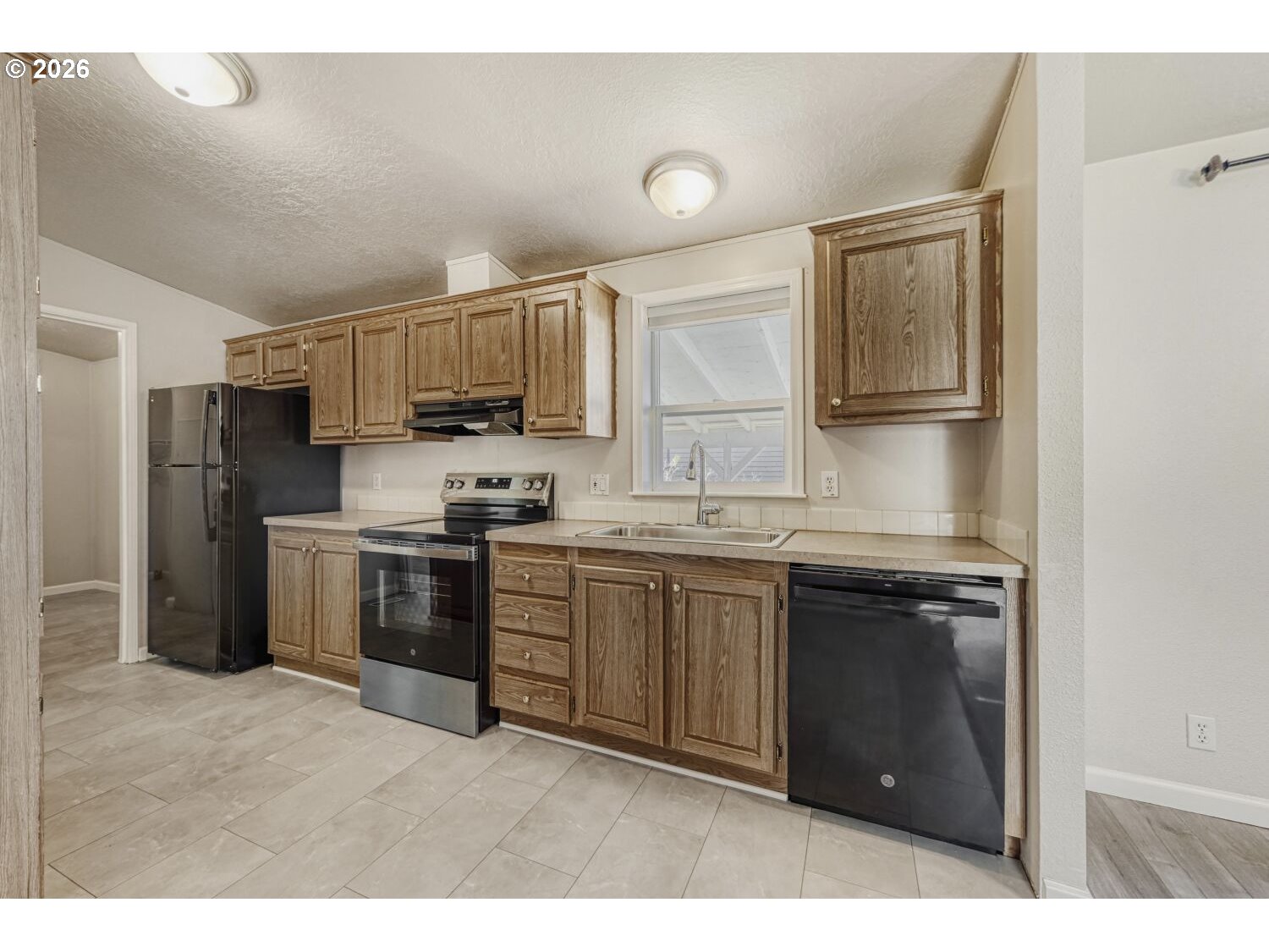 2431 North Fremont Street Cornelius, OR 97113 - Photo 6 of 29 a kitchen with granite countertop a refrigerator stove top oven and sink