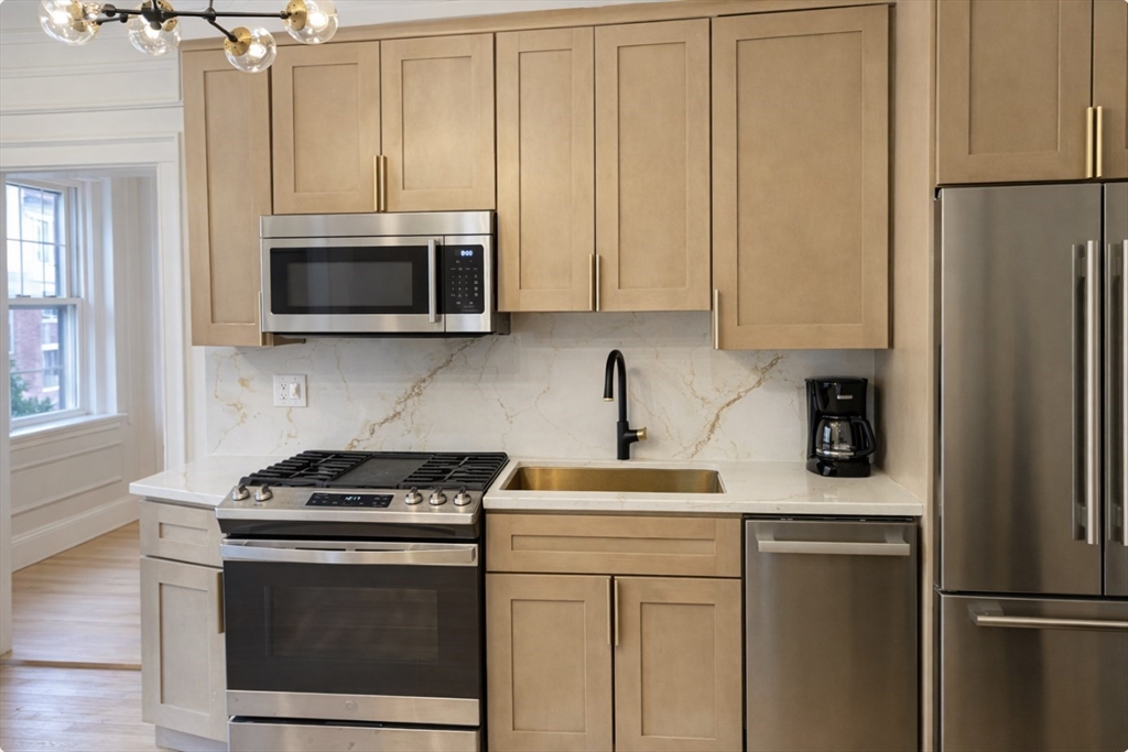 4 Chiswick Road, Unit 34 Boston, MA 02135 - Photo 2 of 10 a kitchen with stainless steel appliances a stove microwave and refrigerator