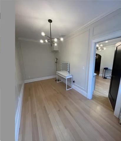 a view of a room with wooden floor mirror and staircase
