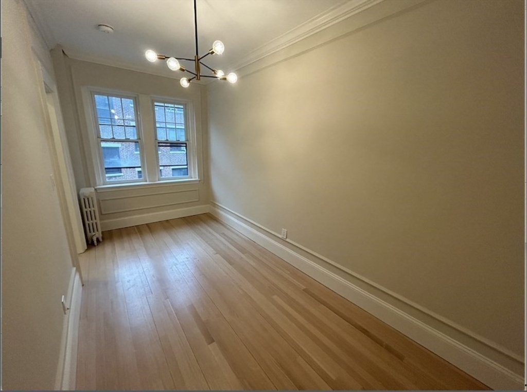 4 Chiswick Road, Unit 34 Boston, MA 02135 - Photo 6 of 10 wooden floor in an empty room with a window